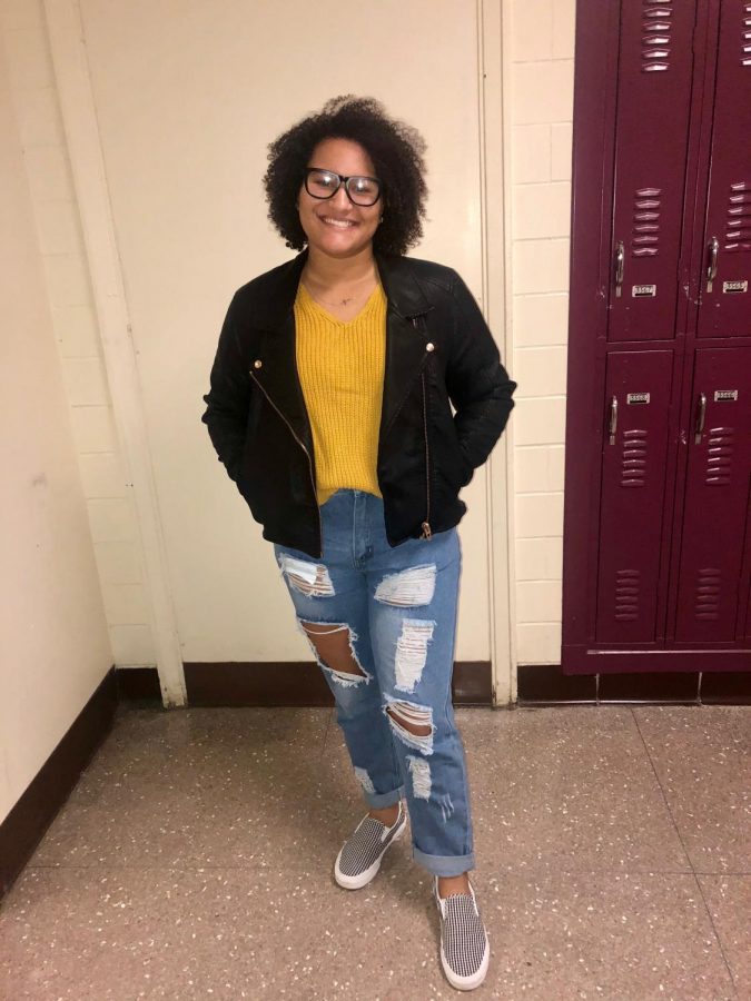 Kayla Tingley, 11th Grade. Here, Kayla chose to show off her yellow knitted sweater tucked into her dark denim 'boyfriend' jeans. Kayla chose her white stripped slip on vans to coordinate with the leather jacket.